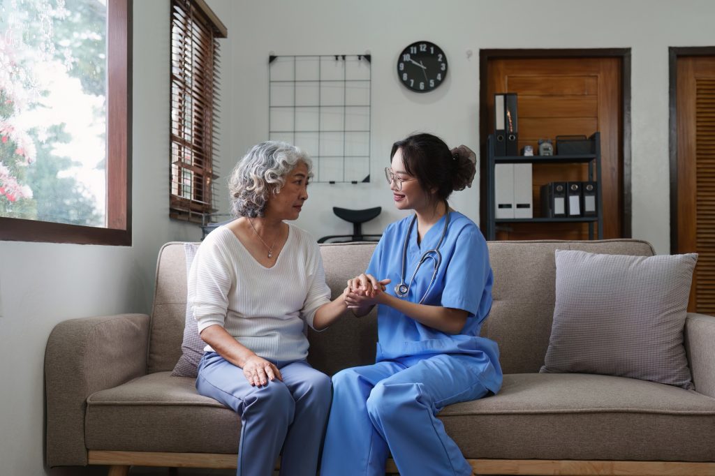 Asian youthful nurse caring for patients or the elderly at home. nursing at home concept