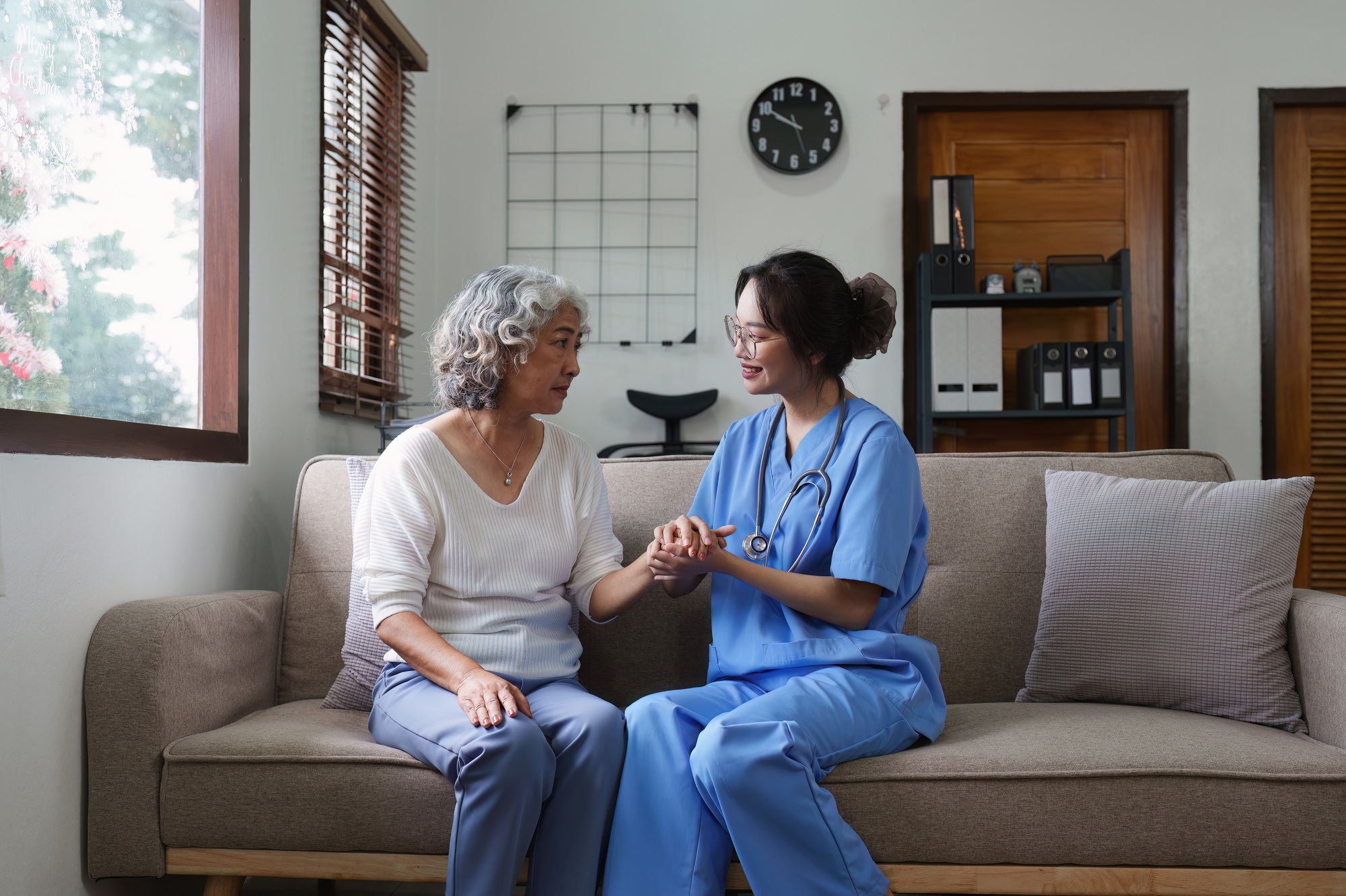 Asian youthful nurse caring for patients or the elderly at home. nursing at home concept